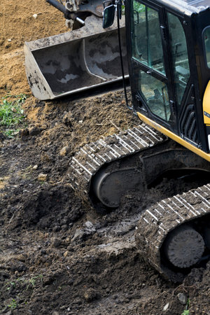 Man and machine working on the siteの写真素材