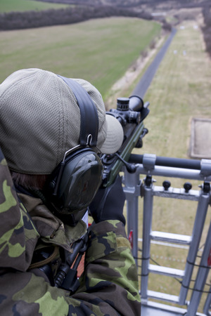 Military sniper aims at a targetの写真素材