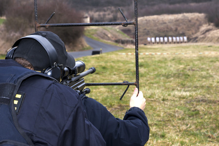 Military sniper aims at a targetの写真素材