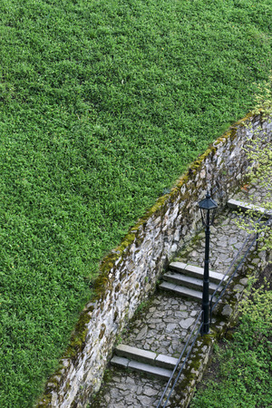 Historical street lamp on the stone wallの写真素材