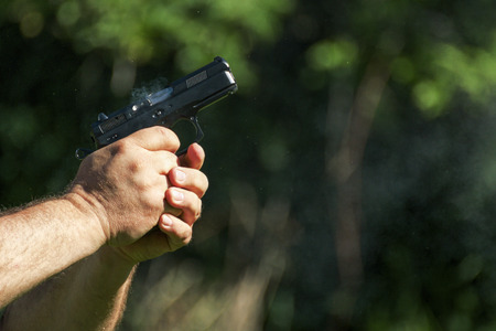 Man practicing shooting with a gunの写真素材