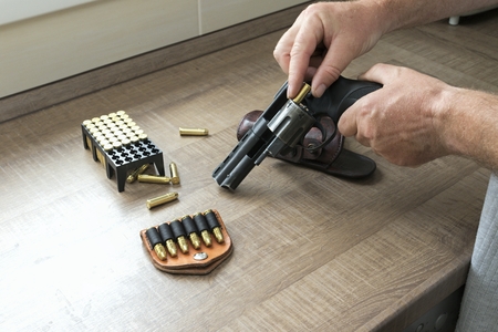 Man reloading an ammunition revolverの写真素材