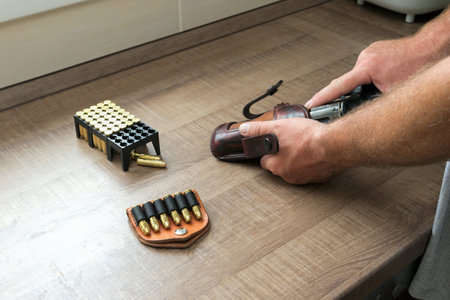 Man reloading an ammunition revolver
