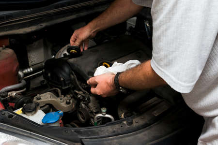 The mechanic fixes the vehicle's engineの写真素材