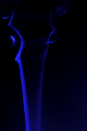 colored smoke on a black backgroundの写真素材