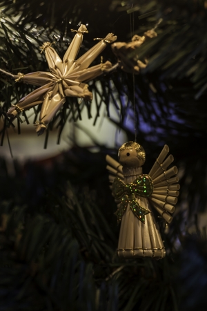 beautiful ornaments made of straw on a Christmas treeの写真素材
