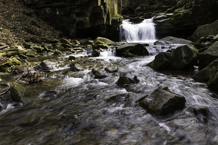 mountain waterfall among big stonesの写真素材