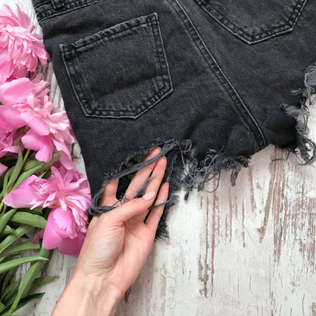 Black denim shorts back on wooden background