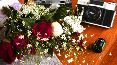 unblown bouquet of purple peony on wooden table near a candleの写真素材