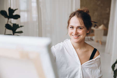 Portrait of smiling woman painting at art studioの写真素材