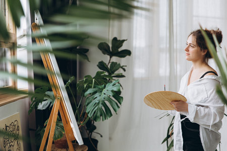 Artist searching for inspiration while looking at canvasの写真素材
