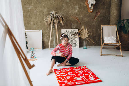 Woman listening music and painting abstract pictureの写真素材