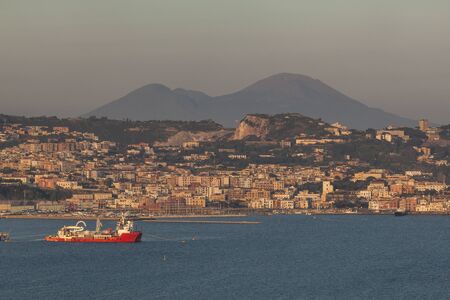 Old town Pozzuoli in Campagna with Vesuvius in background, Italyの写真素材