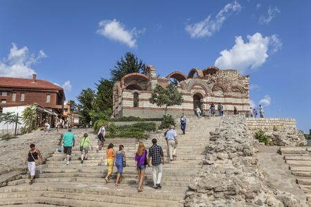 Tourists visiting the church of St John Aliturgetos on the ruins of antique theatreのeditorial素材