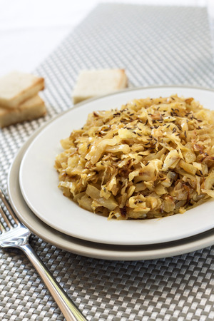 Fried cabbage with caraway and garlic on a plateの写真素材