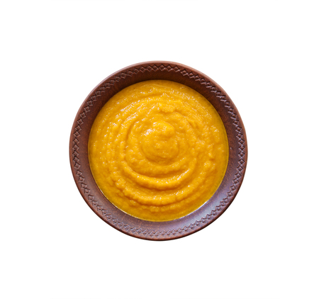 Squash caviar with garlic and tomatoes in a rustic bowl isolated on white background with clipping pathの写真素材