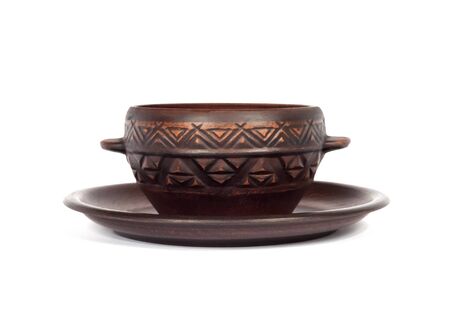 Brown ceramic rustic bowl and a plate isolated on white backgroundの写真素材