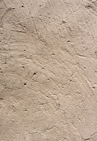 Old cob wall with cracked surface. Vintage background for design purposesの写真素材
