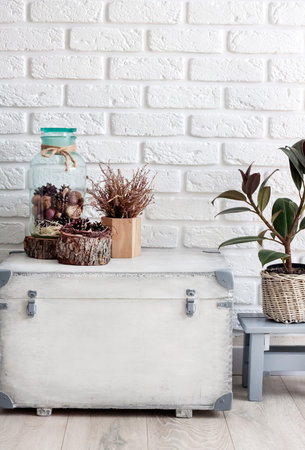 Natural home decor on white wooden box on white wall background. Copy space