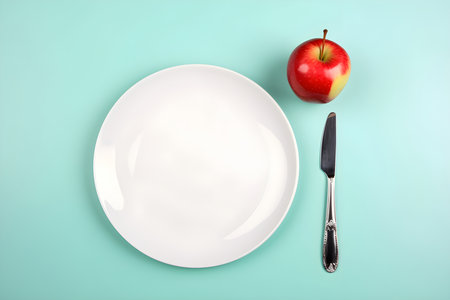 Diet concept. Empty plate, khife and apple. Flat lay, light blue background, space for text. Generative AI contentの素材