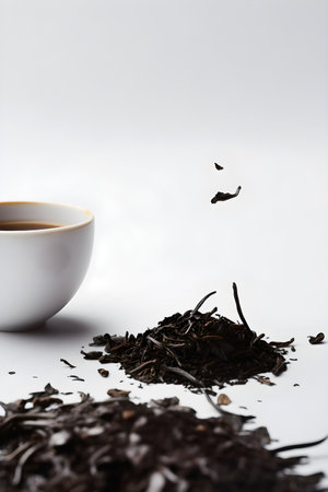 Cup of freshly brewed black tea and dry black tea on white background with copy space. AI generated.の素材
