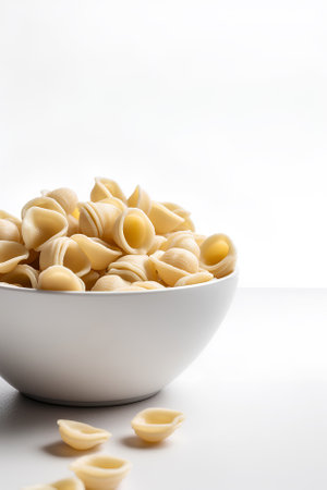 Orecchiette pasta in a bowl isolated on white background as package design element.の素材