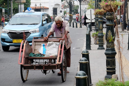 Kota Lama, Semarang / Indonesia - July 6 2020 :  Becak ride along Blendug Church or Immanuael Church...