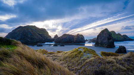 Dramatic sunset over rocks of Gold Beach, Oregonの写真素材