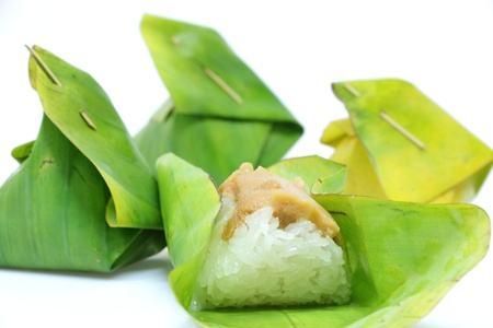 Thai dessert, Sticky rice with steamed custard, wrapped in banana leaves.の写真素材