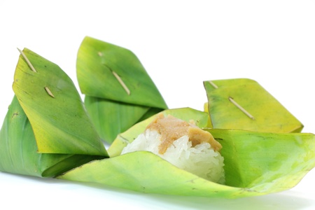 Thai dessert, Sticky rice with steamed custard, wrapped in banana leaves.の写真素材