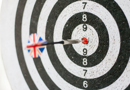 Darts board one Great Britain flag arrow in the middle