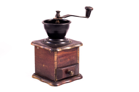 Coffee mill, coffee grinder. Many coffee beans in the background. Texture of the coffee beans on a white background. Smelly, saturated brown arabic coffee beansの写真素材