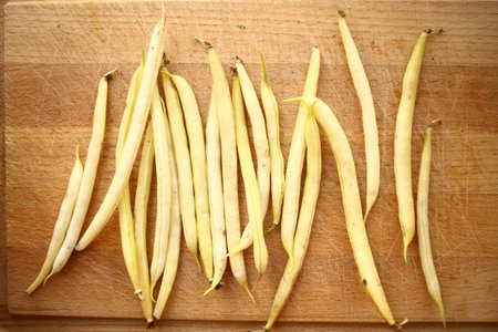Yellow beans (French beans) on rustic wooden table
