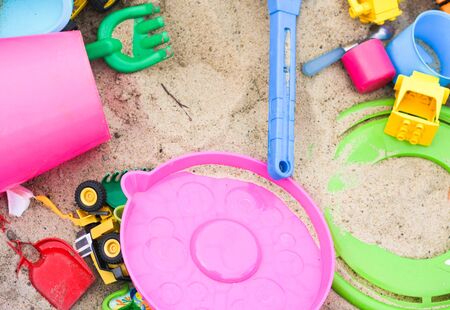 Colorful toys in the sandbox. Happy childhood, way to spend time.の写真素材