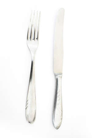 metallic steel fork and knife isolated on white backgroundの写真素材