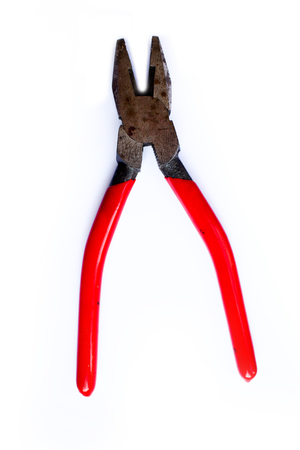 Simple old grungy red pliers isolated on white backgroundの写真素材