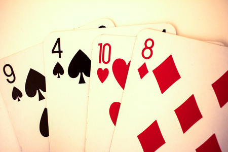 Playing cards close up detail. Black and red cards with a little bit sepia fiterの写真素材