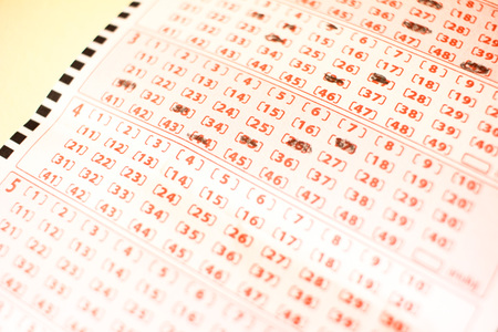 Close up of pink lottery ticket with numbers macroの写真素材