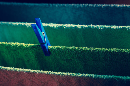 Colorful faded retro vintage background of lines of towels hanging with colorful clips , dark nostalgic moodの写真素材