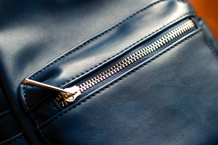 Close up of blue leather women backpack, rucksack detail on wooden backgroundの写真素材