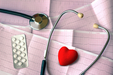 Healthcare composition with red heart, stethoscope and pills. Heart pressure conceptの写真素材