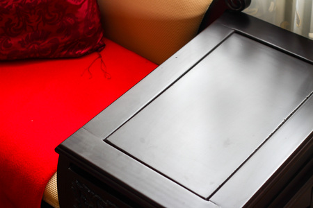 Close up detail of Room with a stylish wooden table red cushionsの写真素材