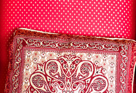 Red pattern cushion pillow on red chair in the room of the hose. Cozy home, composition inside. Close up, detailの写真素材