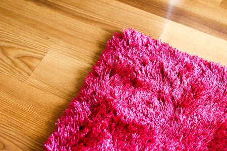Pink purple rug on wooden floor cropped detailの写真素材