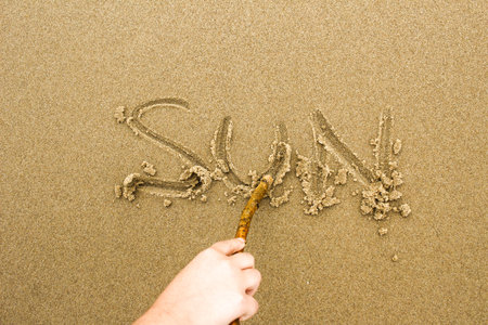 Nice, pleasant and simple sunny summer composition on holidays. Happy relaxing vacations. Text words on wet sand on beach, concept of sunny dayの写真素材