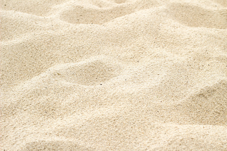 Many holes after footprints in the beach sand backgroundの写真素材