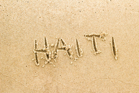 Nice, pleasant and simple sunny summer composition on holidays. Happy relaxing vacations. Text words on wet sand on beach, concept of Haitiの写真素材