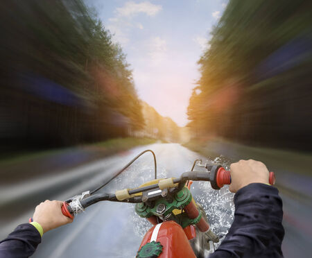 Hands of motorcyclist while ridingの写真素材