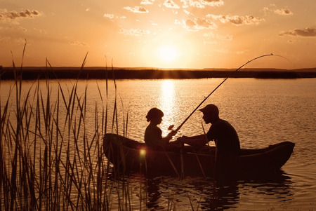Fishing boat on the river at sunsetの写真素材
