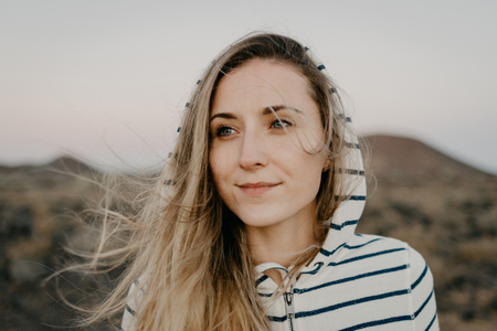 Cute girl is smiling in the mountains in the evening. Tenerifeの写真素材